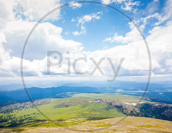 Ultra Wide Panorama Of Skyline. Green Mountains Covered With Forest On The Blue Sky Background.  Amazing View On Green Mountains From A Viewpoint