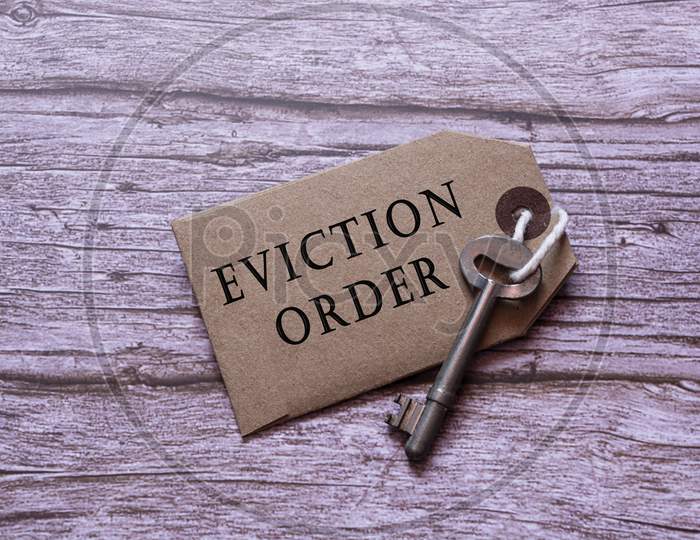 Text On Brown Tag With Key On Wooden Table - Eviction Order