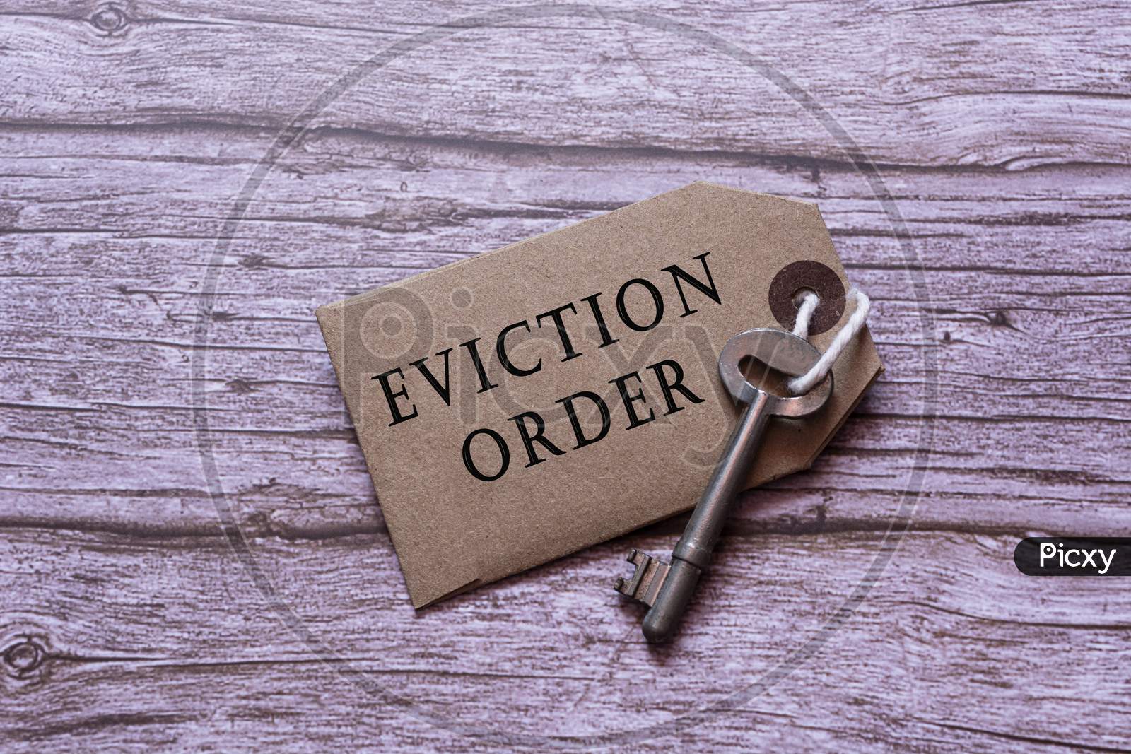 Text On Brown Tag With Key On Wooden Table - Eviction Order