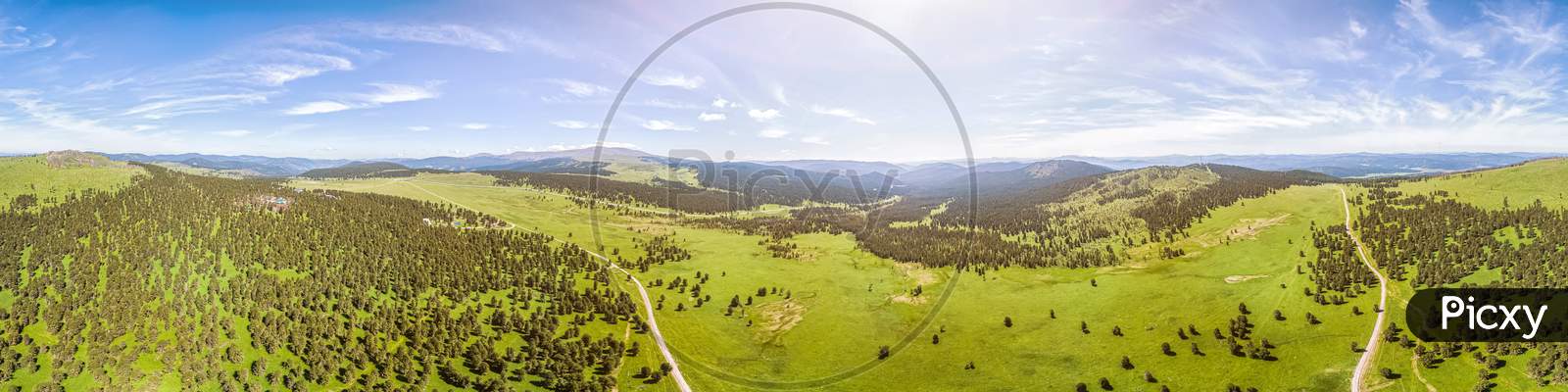 Panorama Of The Mountains  In Altai On A Summer Clear Day. A Landscape View Of Beautiful Fresh Green Field   And  Altai Mountain Background.  Panoramic View Of Beautiful Green Field