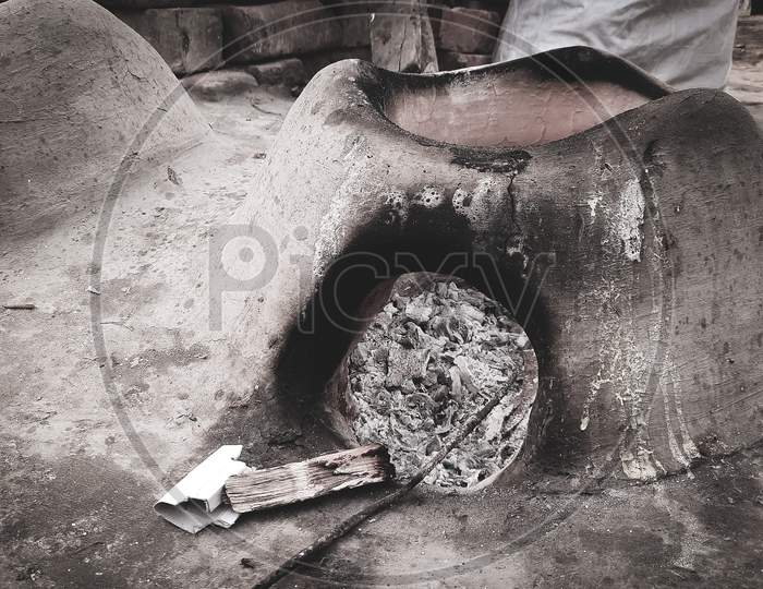 An Earthen Cooking oven, fire extinguished, Wood and coal ashes inside, Countryside