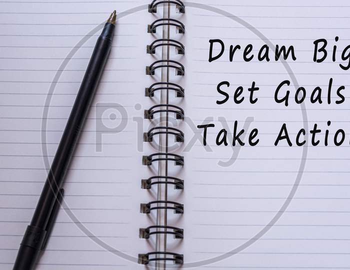 Motivational Quote On Notepad With Pen - Dream Big Set Goal Take Action