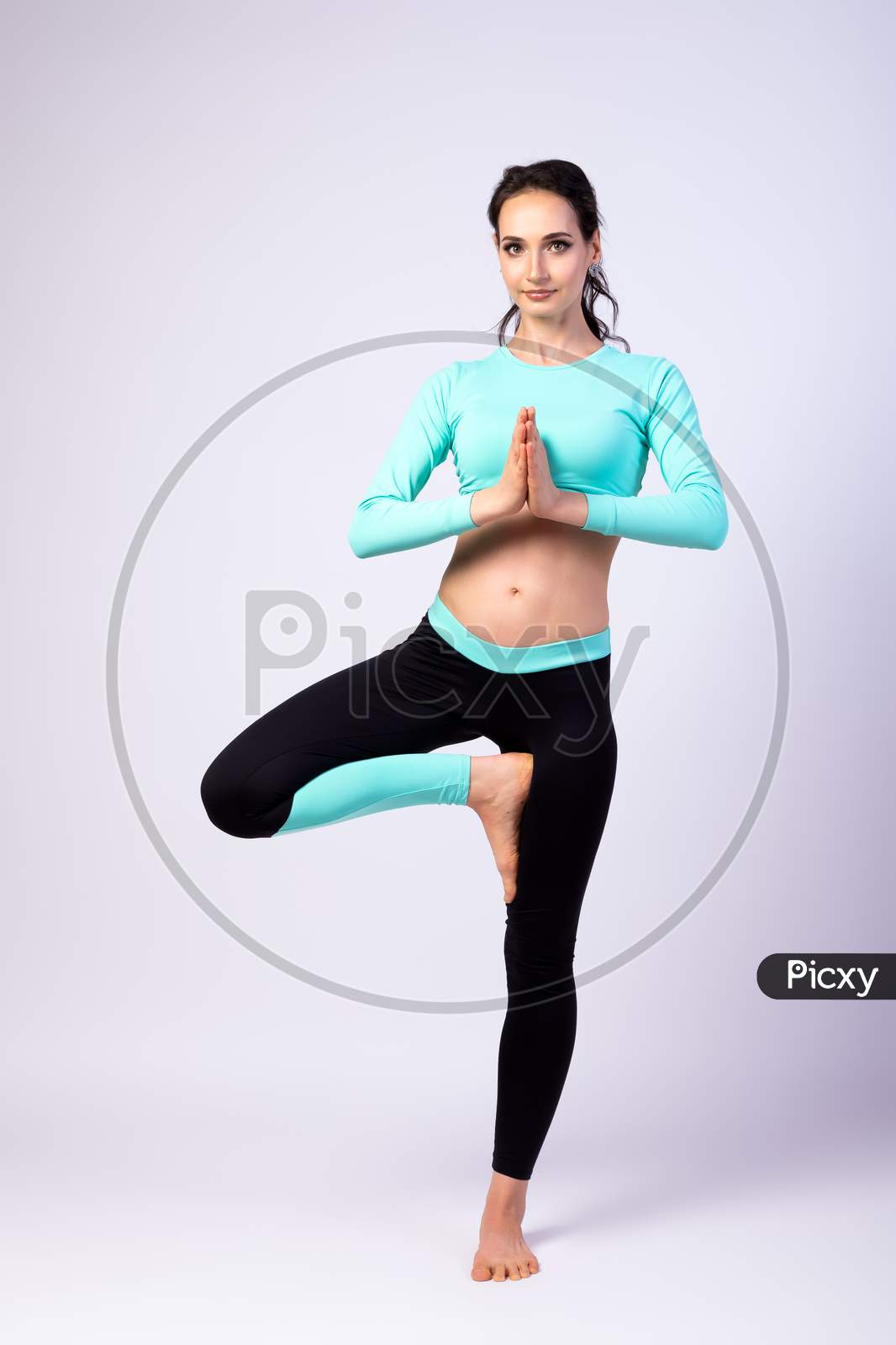 Beautiful Sporty Lady In Fitness Leggings And Top Doing Yoga And Meditation On A White Isolated Background. Healthy And Fitness Lady Concept