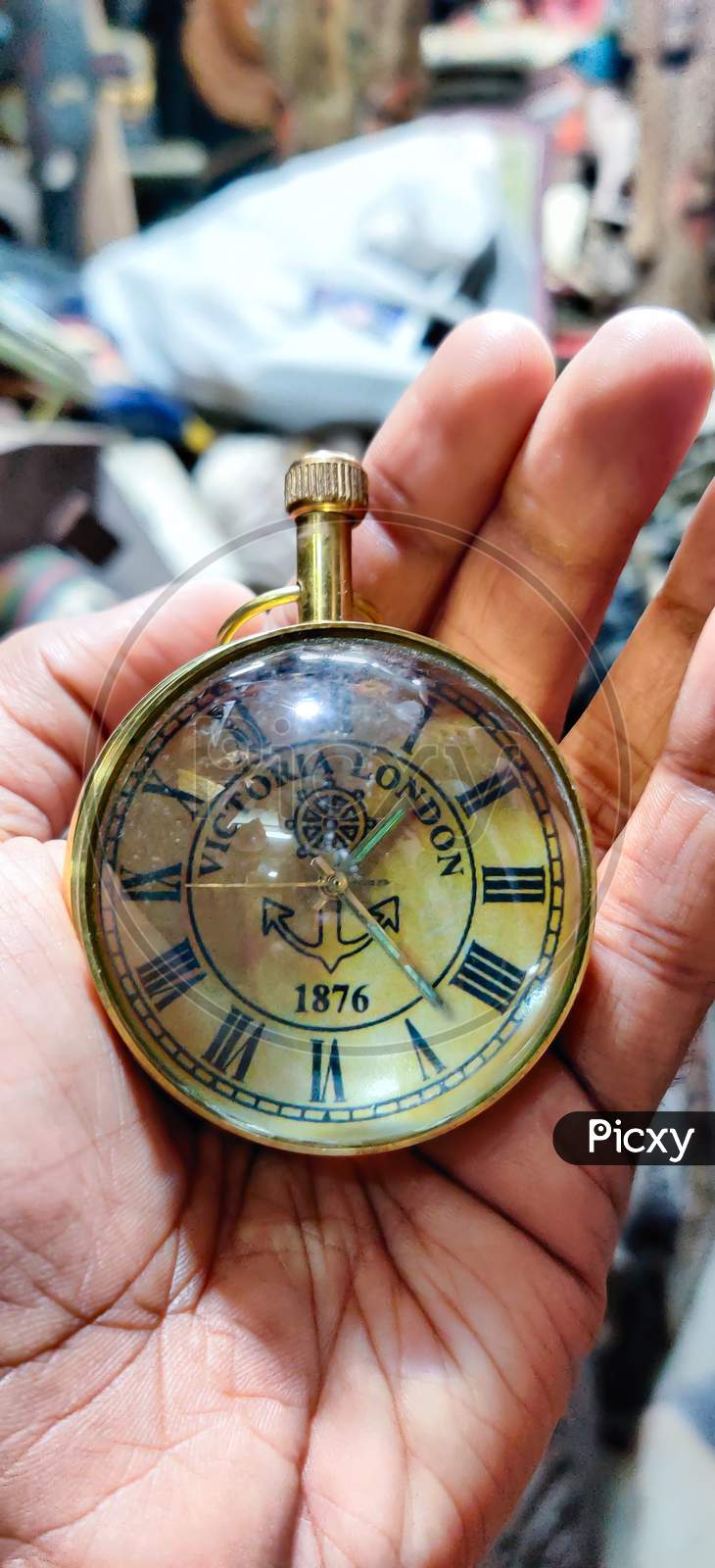 Vintage Golden Pocket Watch On The Chain In Hand On Rock Background, Time Concept