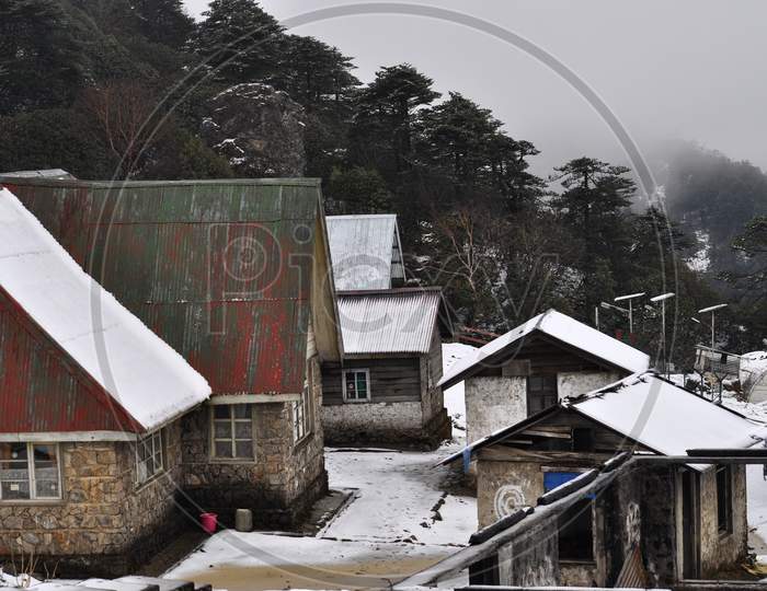 Cluster Of Home Stay Cottage Covered With Snow