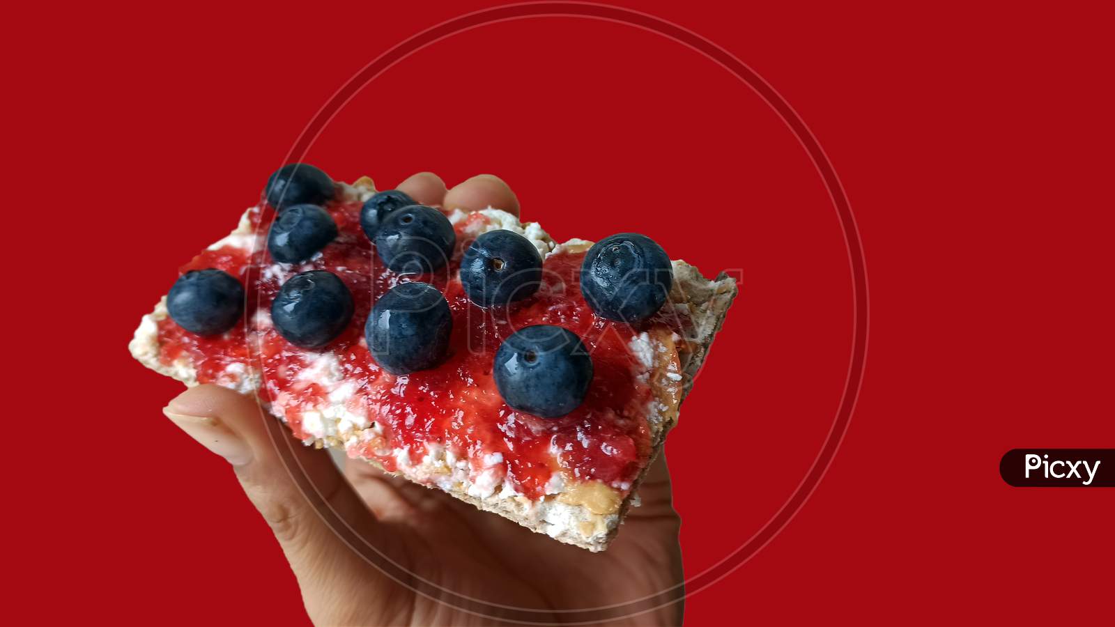 Healthy Delicious Breakfast Concept Of Fiber Crunchy Bread With Peanut Butter, Berry Jam And Bunch Of Blueberry On Top Against Bright Red Background For Copy Paste Text. Light Snacks For Fitness Diet.