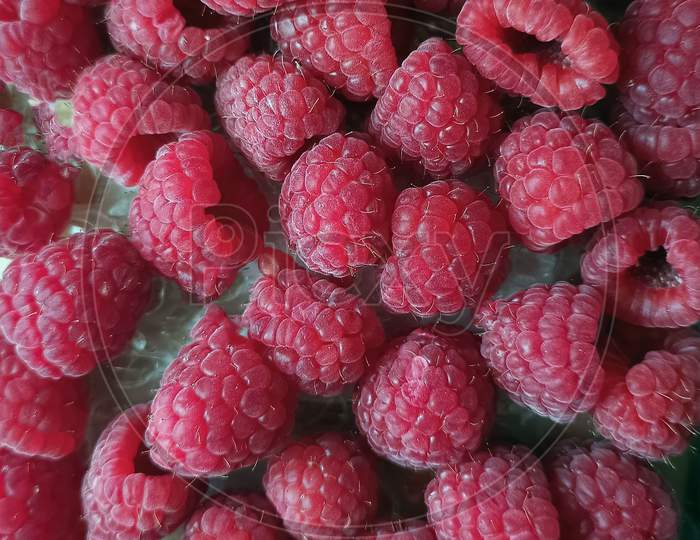 Pile Of Ripe Rasberry Fruit Horizontal Close Up Background. Macro Shot Of Bunch Of Fresh Rasberries Fruits