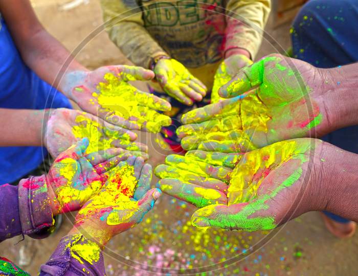 Color Festival In India. Human Hand Making Colors On Hand And Playing Holi Festival With Gulal Colors.