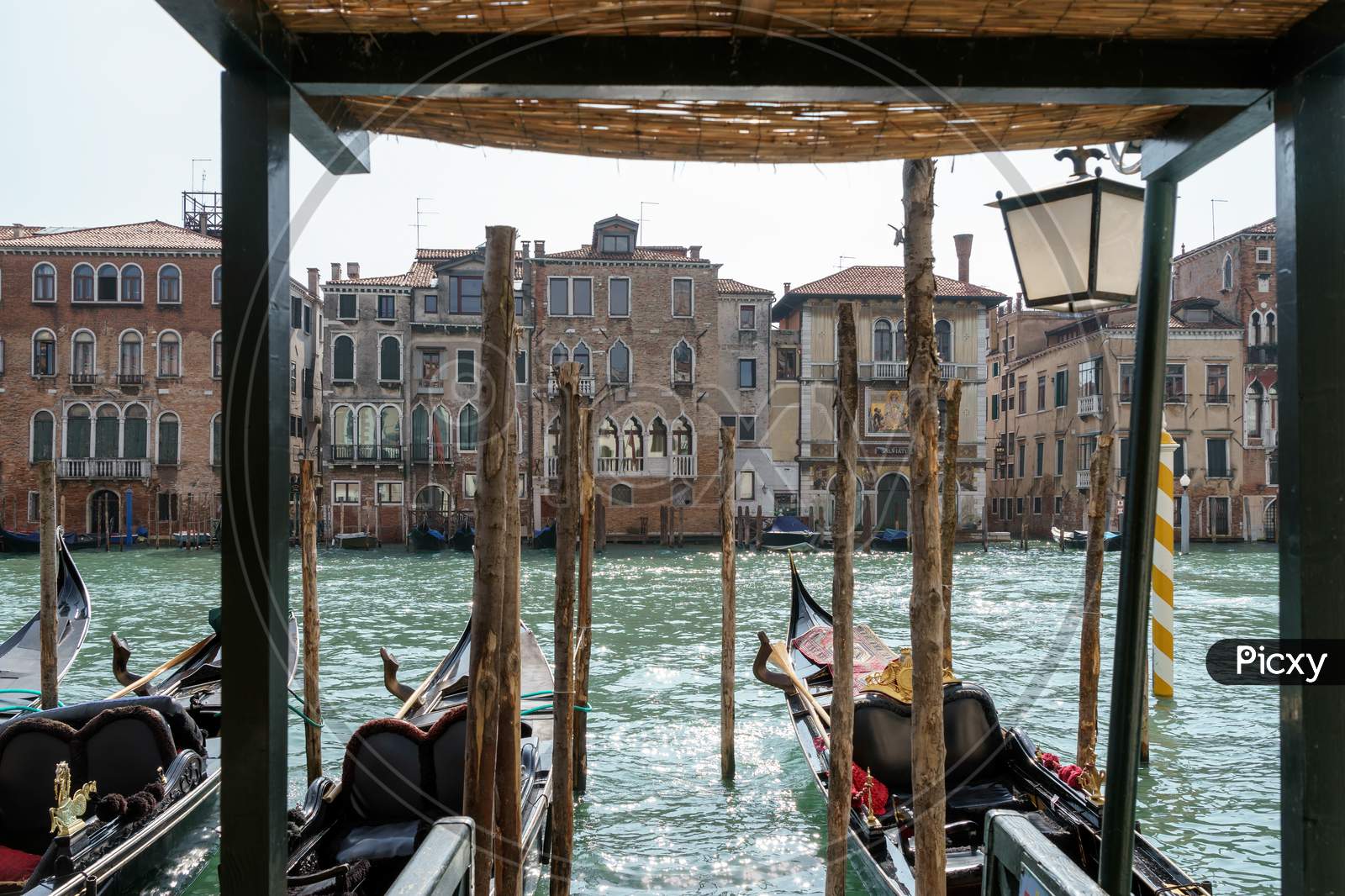 Gondolas Moored Along A Canal In Venice