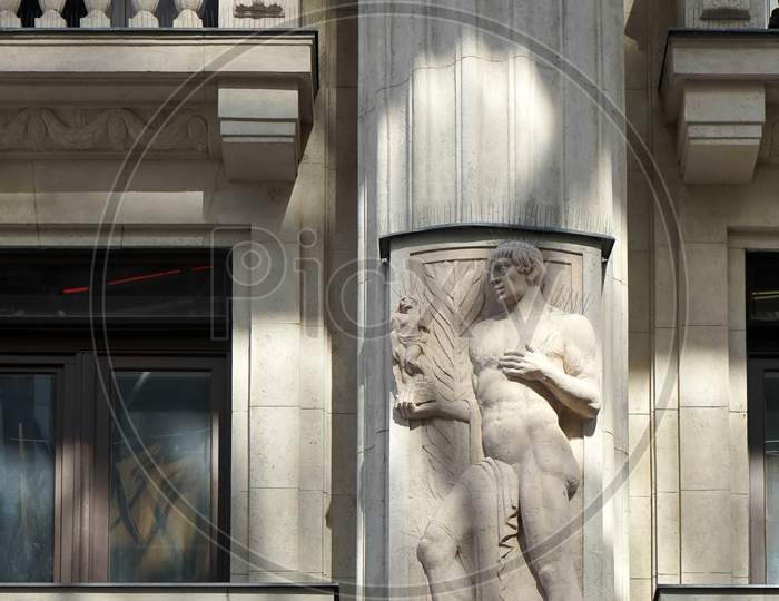 Statue Of A Male Figure On An Apartment Block In Budapest