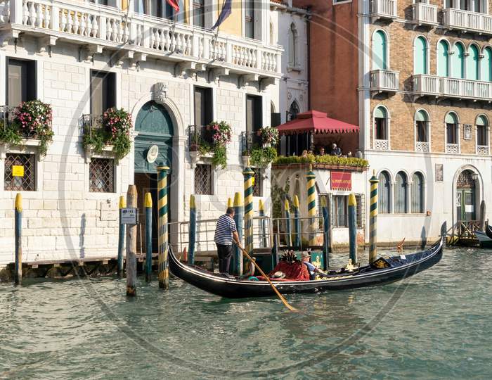 Gondolier Ferrying A Passenger Along The Grand Canal