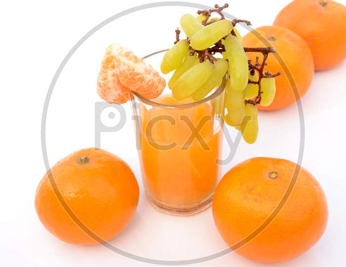 The Healthy Orange Juice With Green Ripe Grape , Isolated On White Background.