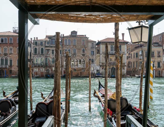 Gondolas Moored Along A Canal In Venice
