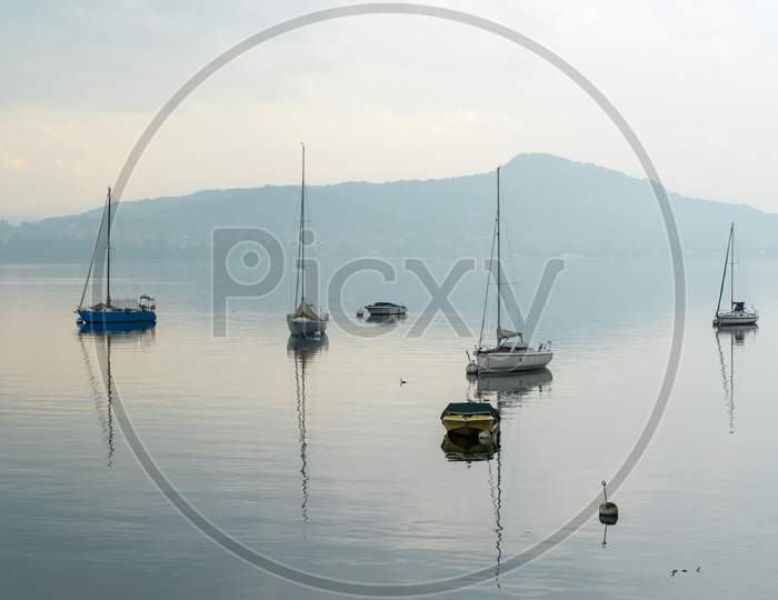 Yachts In The Early Morning Mist At Lesa Lake Maggiore Piedmont Italy