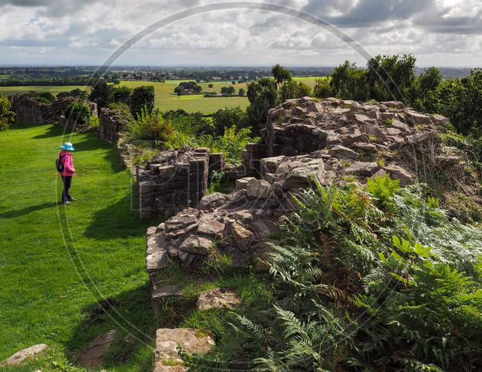 Woman Looking At Ancient Ruins Of Beeston Castle