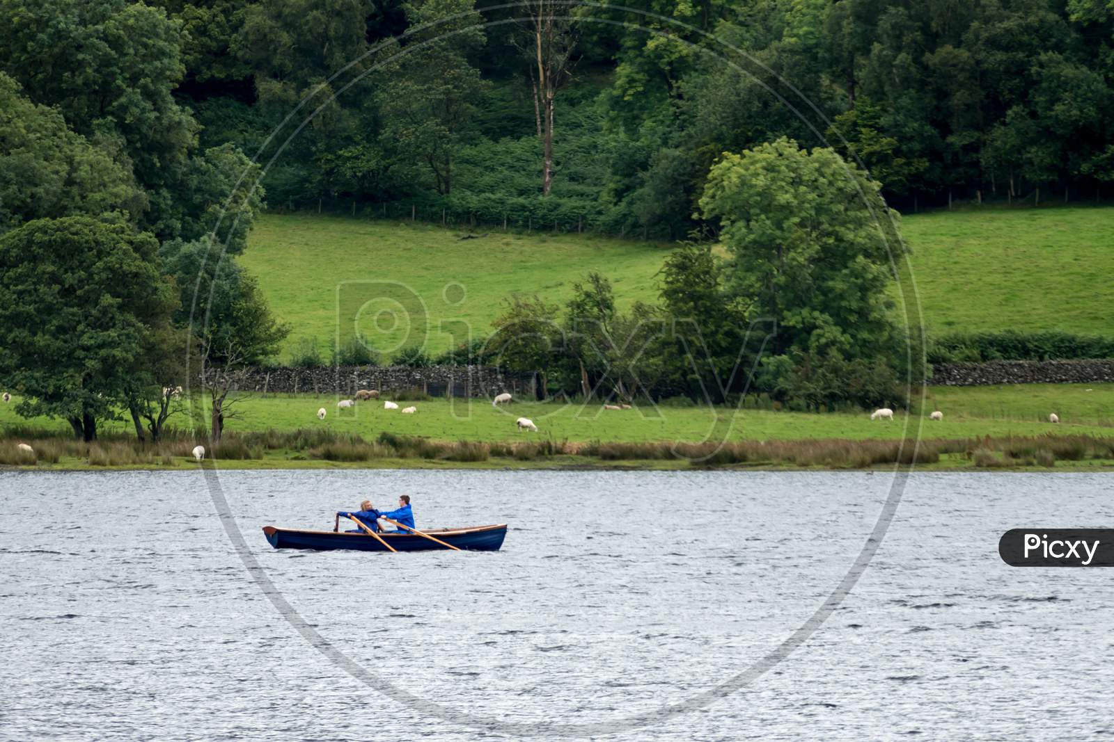 Two People In A Rowing Boat On Coniston Water