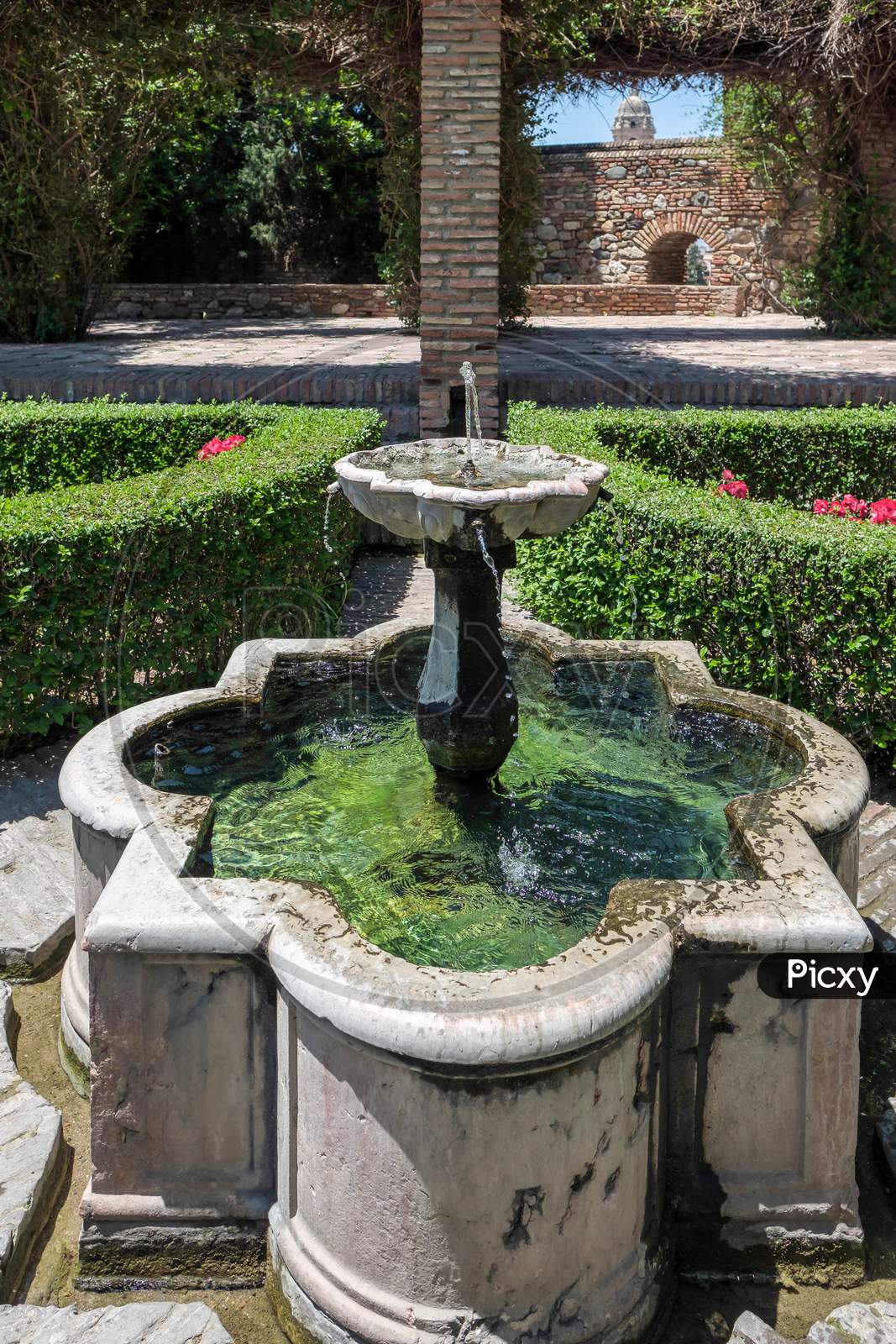 View Of The Fountain In The Alcazaba Fort And Palace Gardens In Malaga