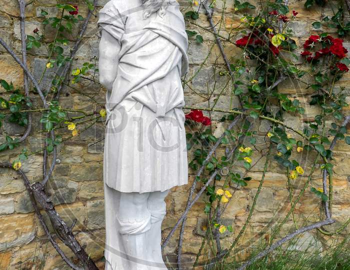 Old Statue Of A Bearded Man In The Garden At Hever Castle