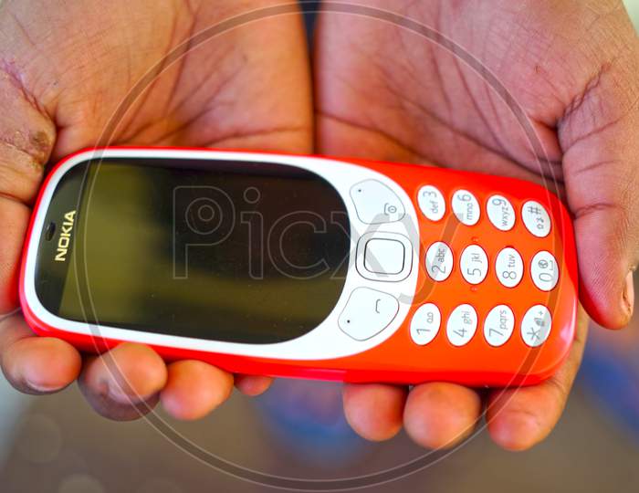 Red Nokia Mobile Series Phone With White Keypad. Attractive Keypad Mobile Handset For Communicating Each Other.