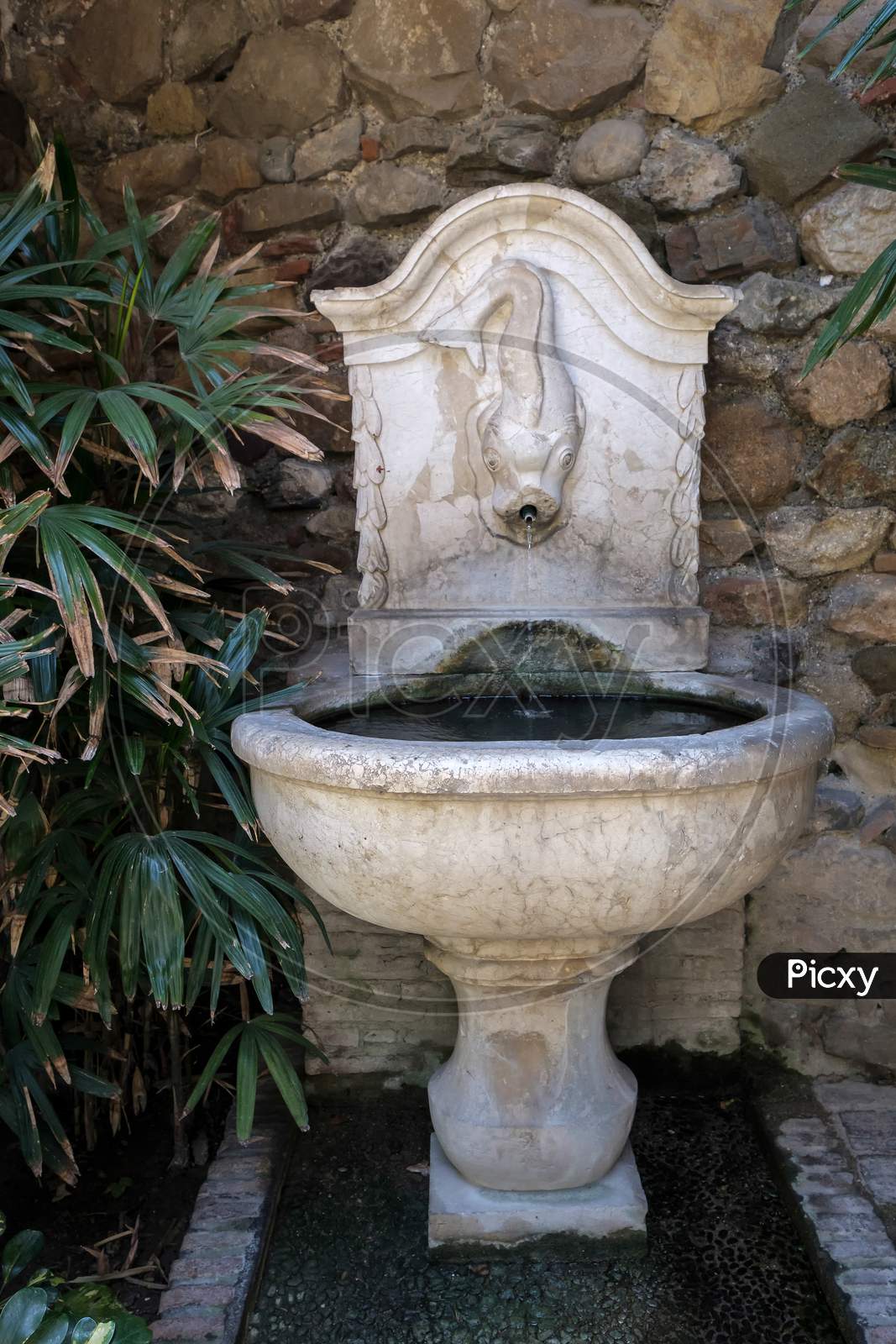View Of A Fountain In The Alcazaba Fort And Palace Gardens In Malaga