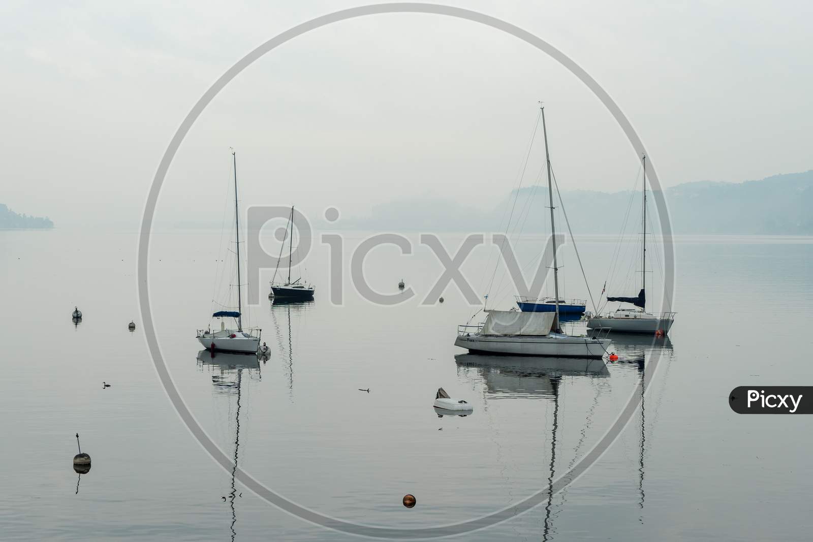 Yachts In The Early Morning Mist At Lesa Lake Maggiore Piedmont Italy