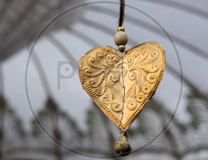 Golden Decorative Heart  Dangling From A Parasol In Marbella