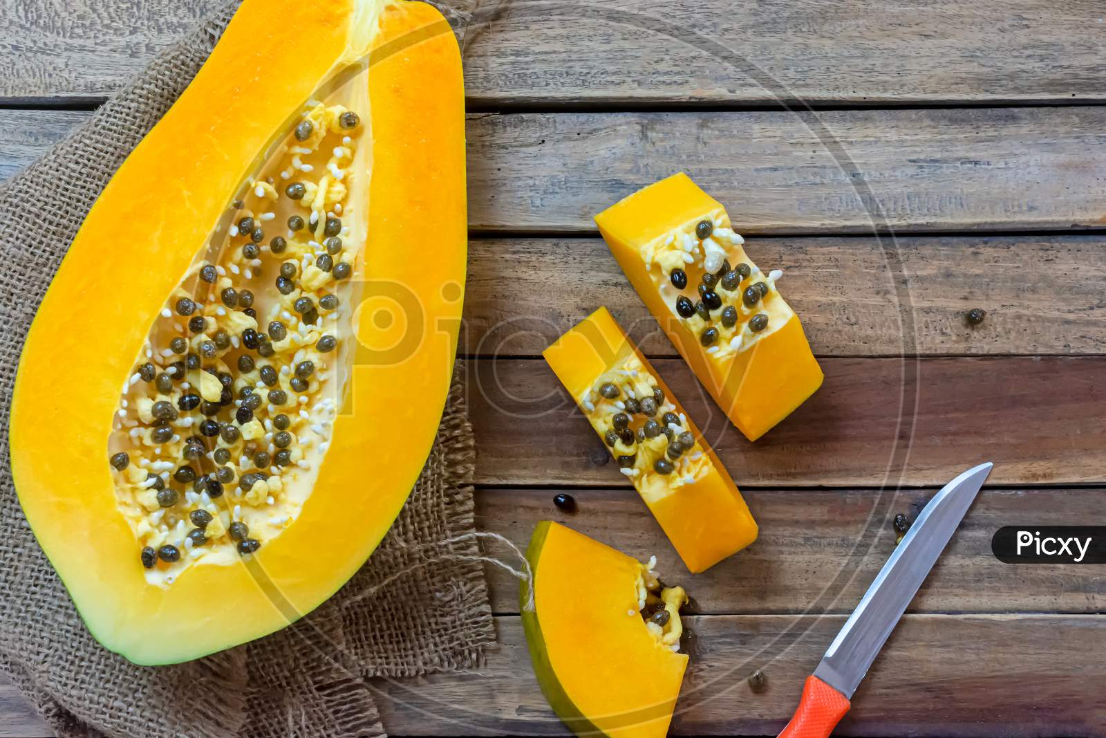 Image Of Fresh Slices Of Papaya Fruit With Sackcloth And Knife On Wooden Background Tropical Fruit Uo8651 Picxy