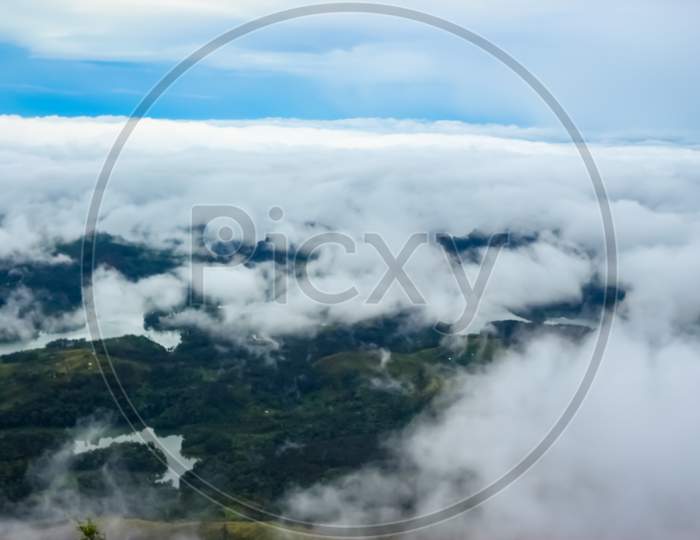 Beautiful Ariel View Of Misty Clouds Passing Over The Mountains - Munnar, Kerala, India.