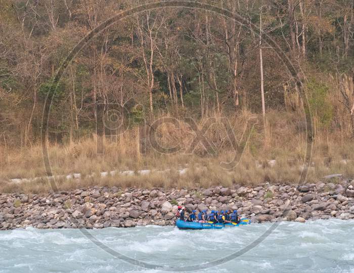 the rafting boat moves in its motion with the waves of water while river rafting in rishikesh uttarakhand, India