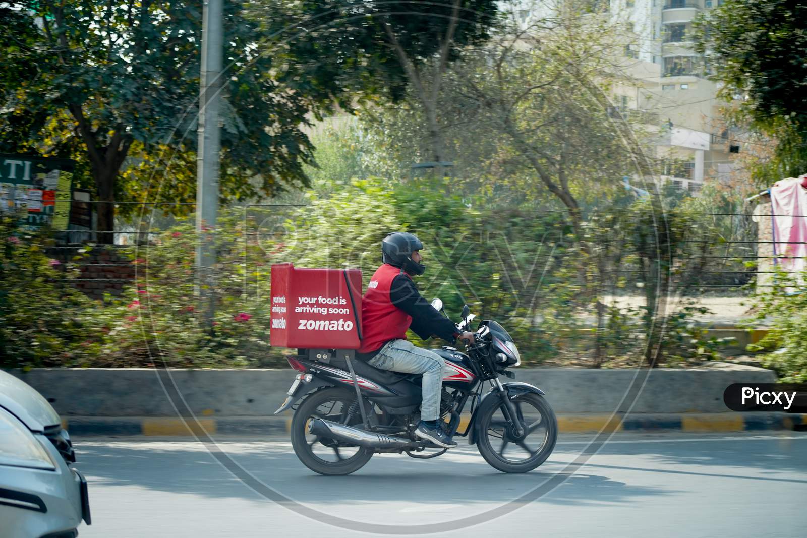 Zomato Delivery Boy With Red Hot Box For Food On A Bike Zooming At High Speed To Deliver Orders For The Upcoming Foodtech Startup From India Which Has Gained A Lot During The Covid Coronavirus Pandemic