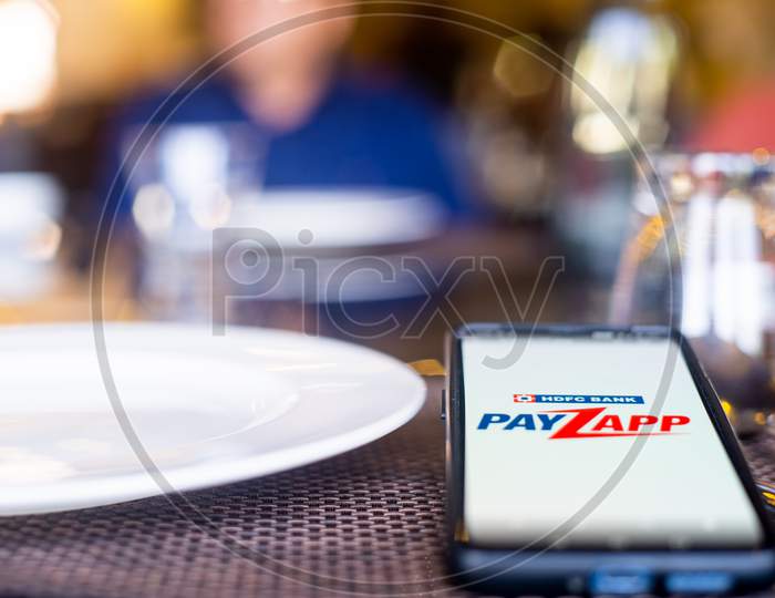Blue Cloth Mask With Mobile Phone At Side With A Payzapp Logo In Restaurant Showing The Popularity Fo Safe Eating Out And Ordering In As Coronavirus Cases Increase In India