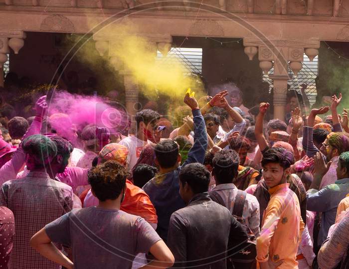 People Enjoying The Holi Of Nandgaon. Throwing Colors In Air