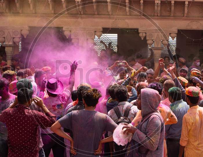 People Enjoying The Holi Of Nandgaon. Throwing Colors In Air