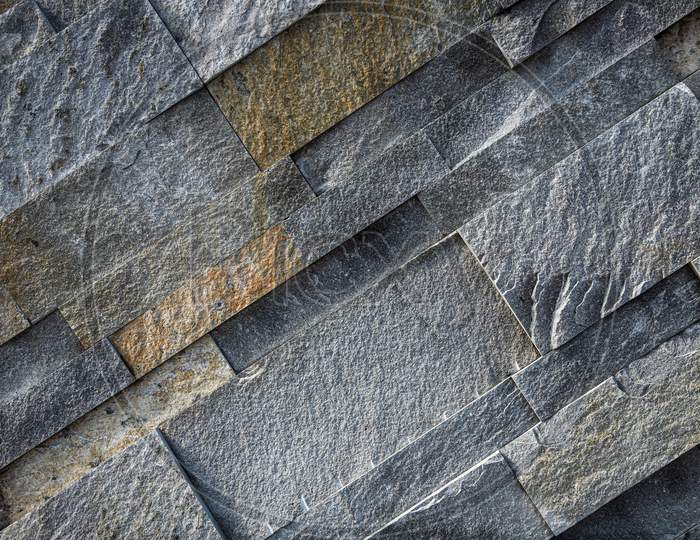 Background Of Gray And Brown Stone Wall Made With Blocks . Pattern Of Slate Wall Texture And Background