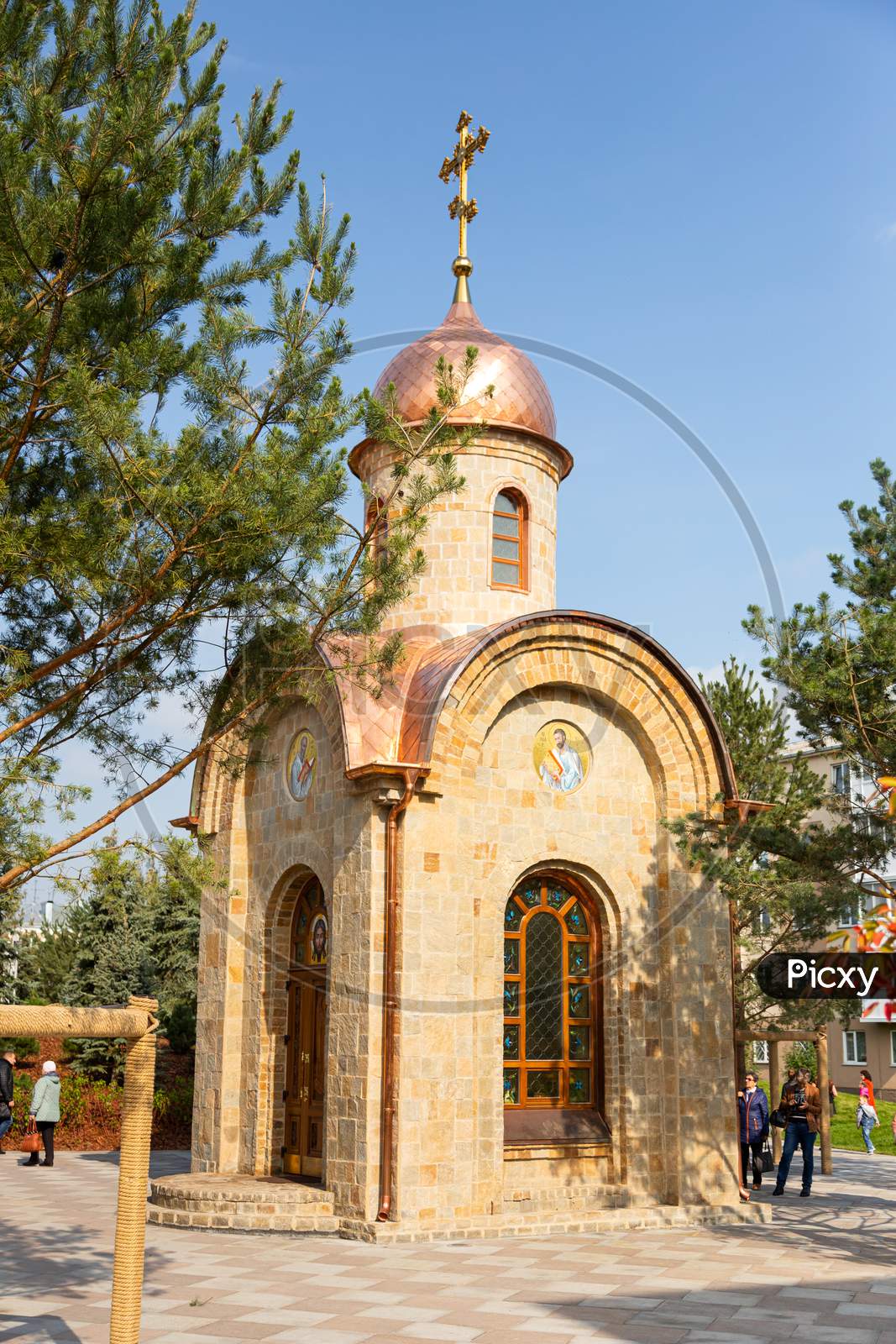 A Small City Chapel Made Of Stone With Golden Baths And Icons Located In The City Park. The Concept Of The Orthodox Church.