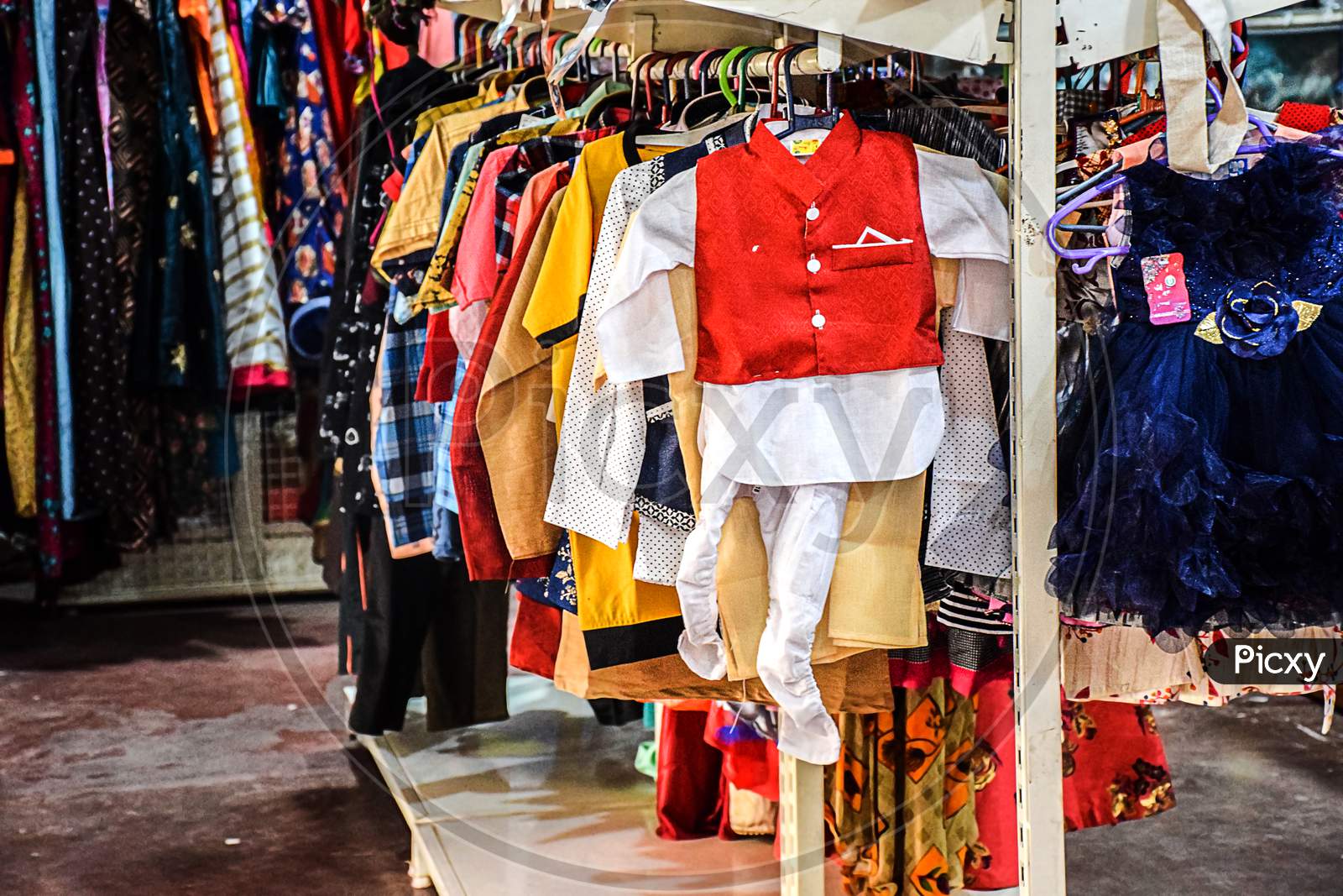 Stock Photo Of Children Cloths Hanging On Hanger In The Display Of Kids Clothing Store At Kolhapur Maharashtra India.