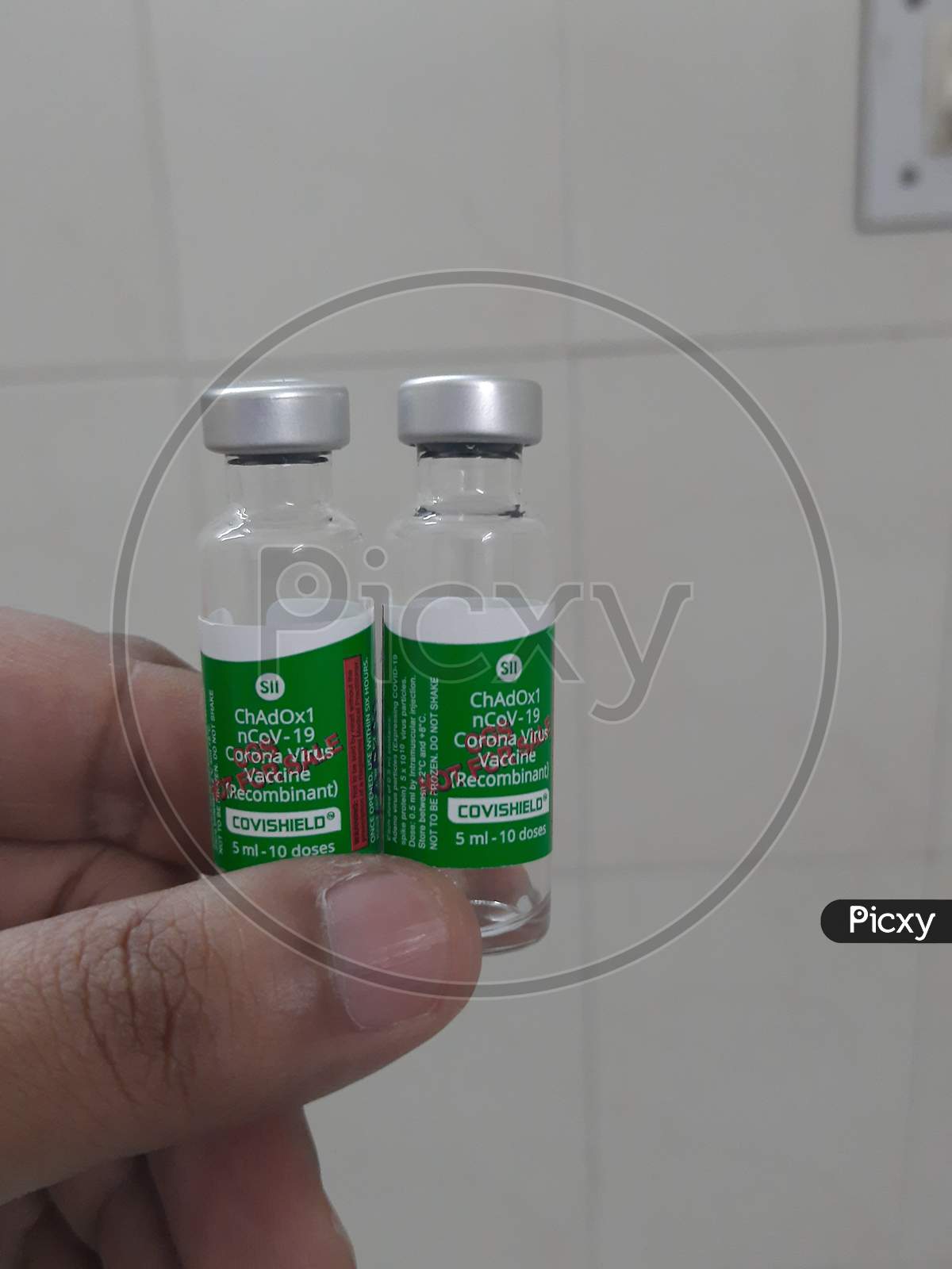 Closeup Photo Of Covishield Vaccine Vials In Hand In White Background..