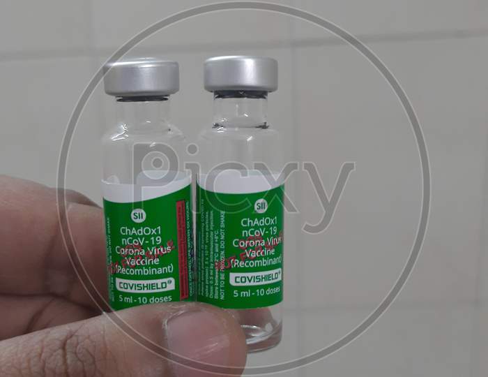 Closeup Photo Of Covishield Vaccine Vials In Hand In White Background..
