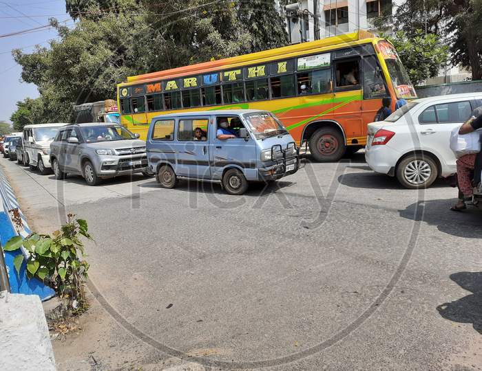 Closeup Of Private Bus And Group Of Cars Waiting In A Traffic Jam At Bangalore During Mid Day At Summer.
