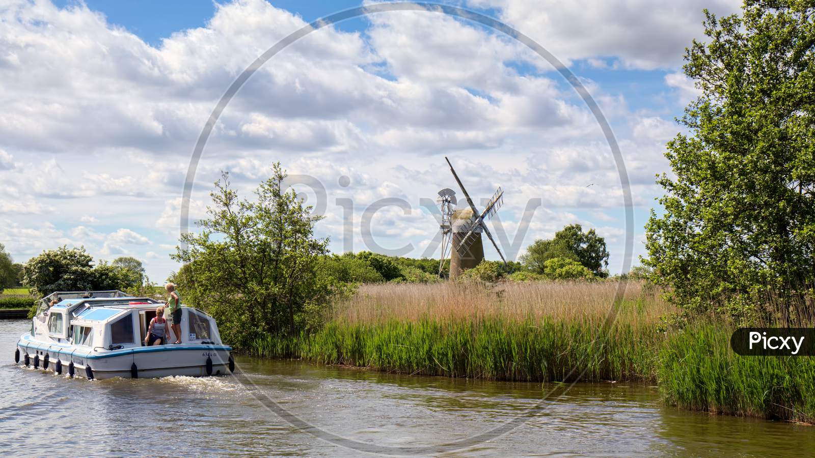 View Of A Boat Passing Turf Fen Mill At Barton Turf