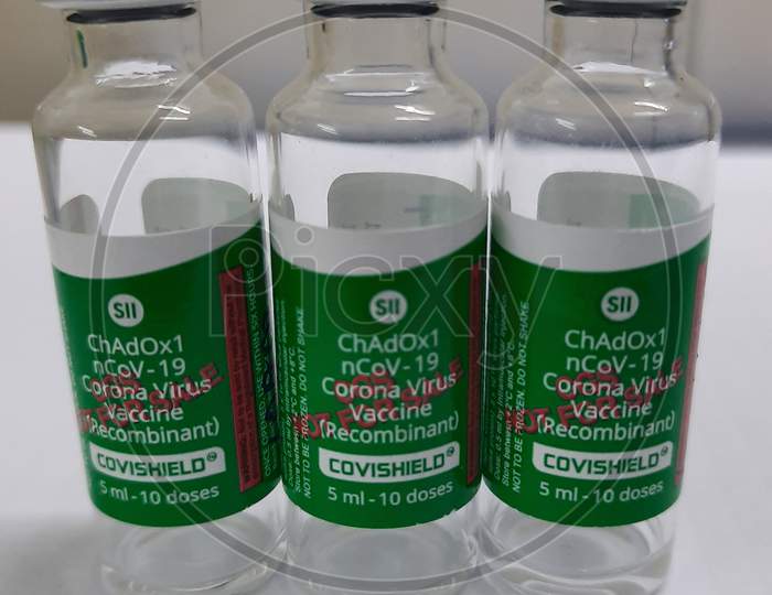 Closeup Photo Of Three Covishield Vaccine Vials In White Background.