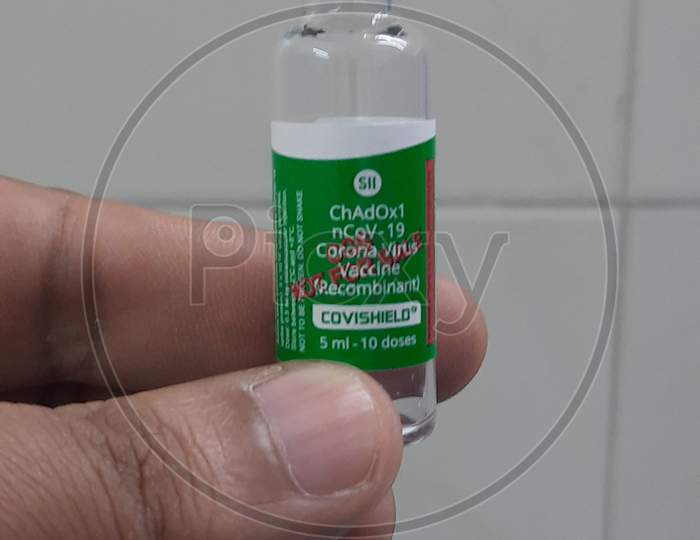 Close Up Photo Of Covishield Covid 19 Vaccine Vial Holding In Hand.
