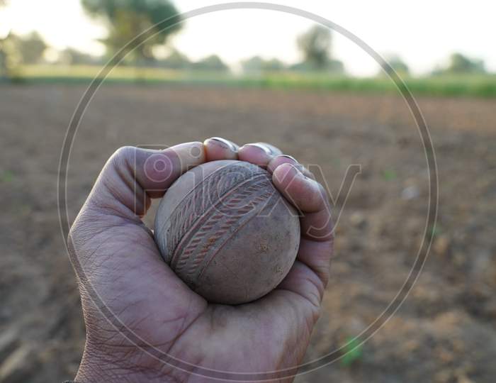 Turbo Street Cricket Ball Closeup View. Cork Core Leather Ball For Cricket And Tennis Use. Old Rustic Ball Closeup With Sunlight.
