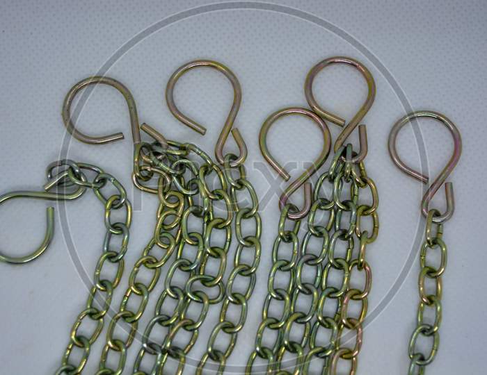 Unusual bright metal chains with overflows located chaotic way on a white background.