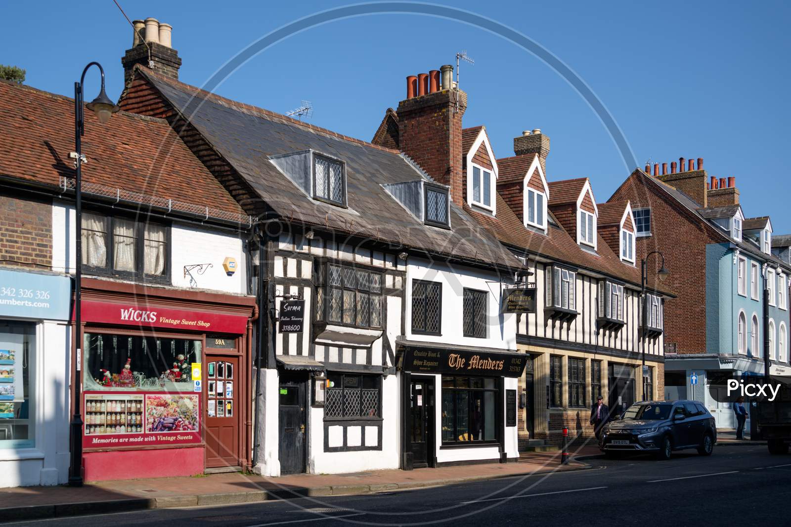 East Grinstead, West Sussex, Uk - March 1: View Of Shops In The High Street In East Grinstead On March 1, 2021. Two Unidentified People