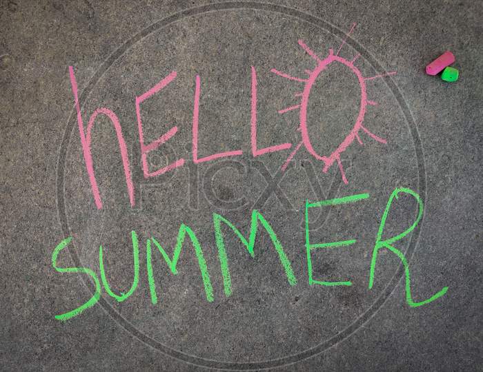 The Inscription Text On The Grey Board, Hello Summer. Using Color Chalk Pieces.