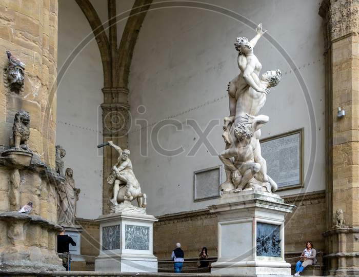 Florence, Tuscany/Italy - October 19 : Statue Of The Rape Of The Sabine Women By Giambologna, In The Loggia Dei Lanzi In Florence On October 19, 2019. Four Unidentified People