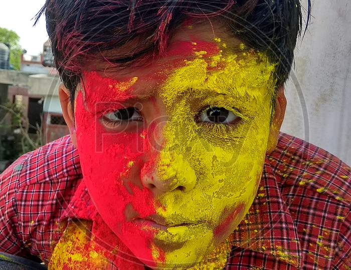 Holi (A Festival of Hindu Religion in India) also called Festival of color, Different Mood and expressions. Child or Kid playing Holi, New Delhi INDIA