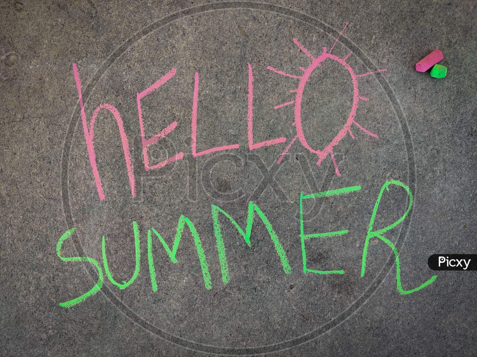 The Inscription Text On The Grey Board, Hello Summer. Using Color Chalk Pieces.
