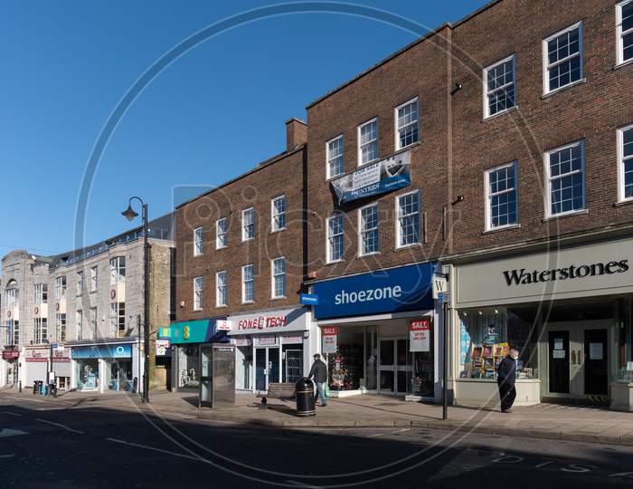 East Grinstead, West Sussex, Uk - January 25 : View Of Shops In The High Street In East Grinstead On January 25, 2021. Two Unidentified People